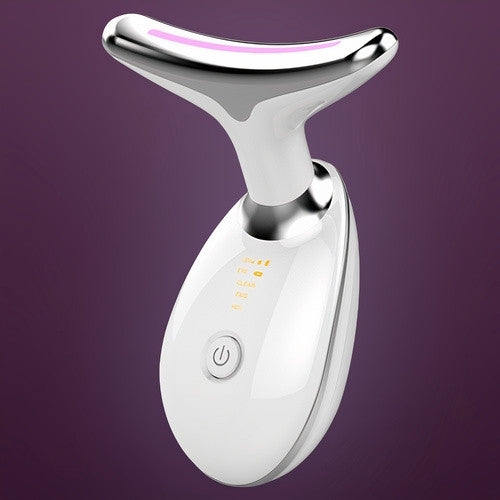 portable Micro face massager with red light therapy against a purple background.